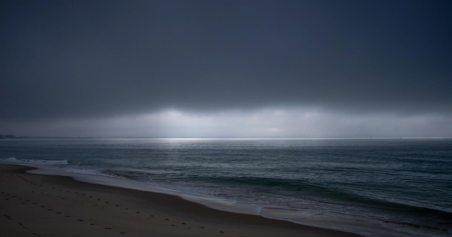 image of a storm covering the beach