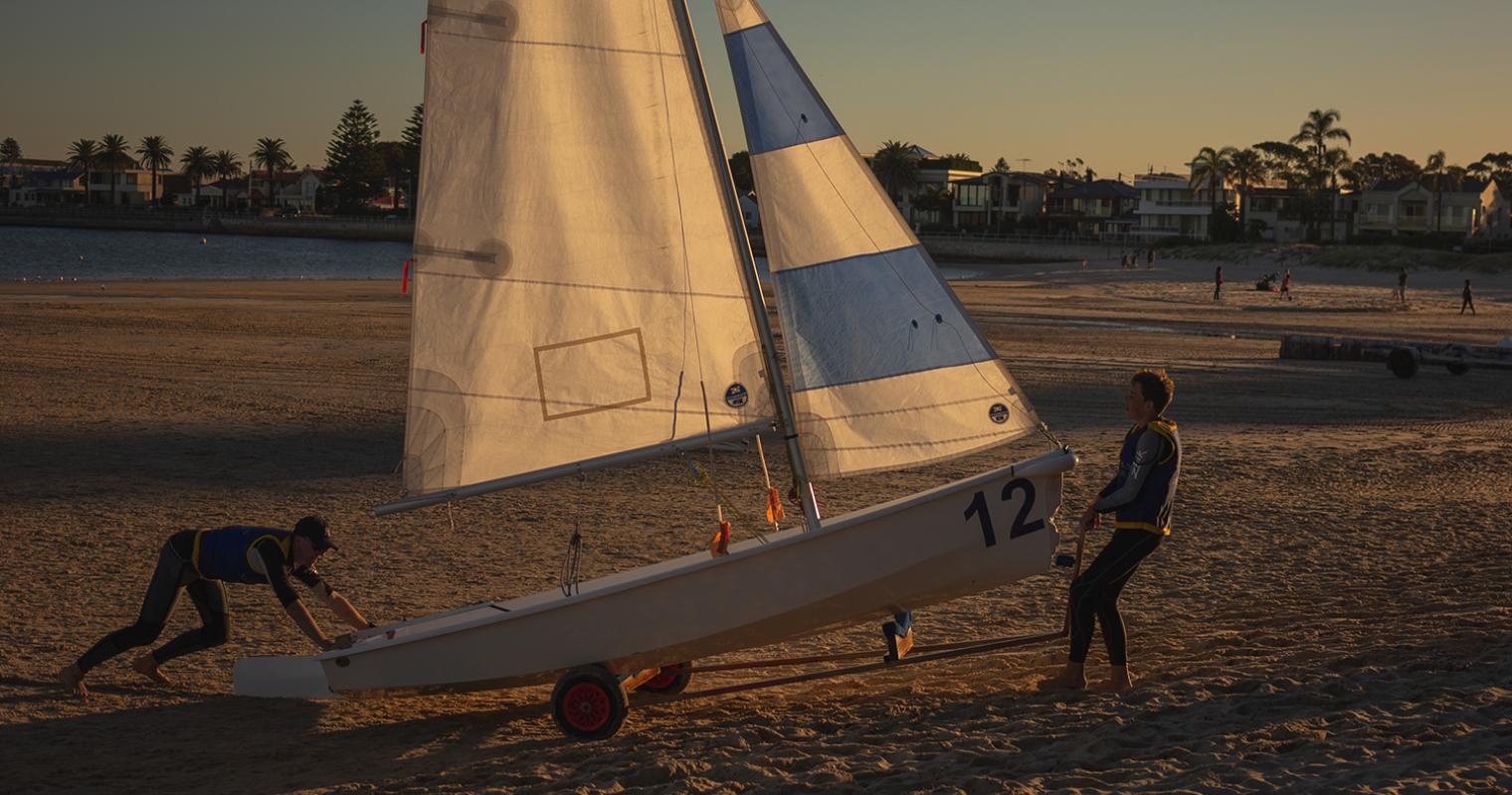 image of sail boat being dragged onto beach
