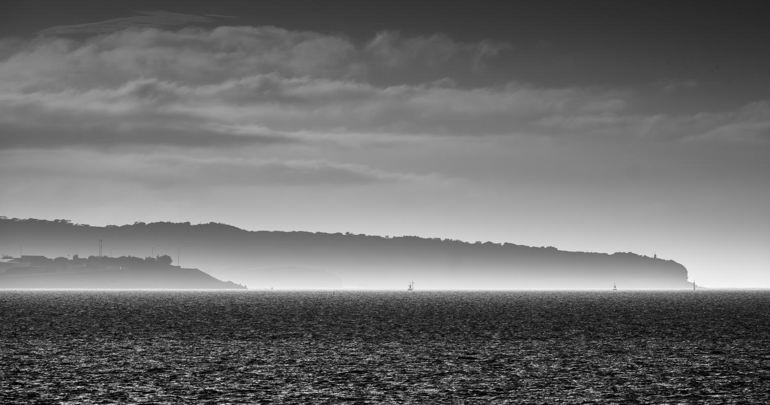 image of headlands behind morning beach fog